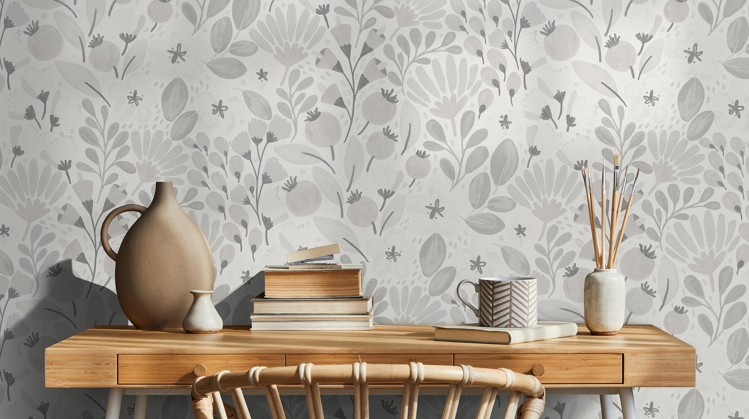 Wallpaper designs being crafted by hand at a work table